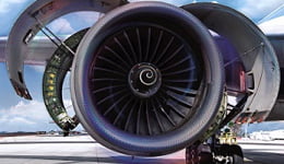 Girando la rueda de un avión en colores azul, gris y rosa, ilustrando el uso de lubricantes Mobil en productos de alta tecnología