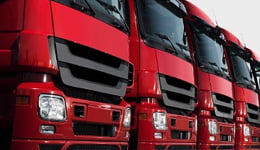 Flota de camiones rojos que ilustra en diagonal el uso de lubricantes de servicio pesado Mobil